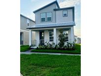 Charming two-story home featuring a well-manicured lawn and a welcoming front porch at 16454 Silver Brook Way, Winter Garden, FL 34787