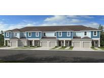 Charming new townhomes featuring coordinated color schemes, garages and manicured lawns at 2208 Portrait St, Kissimmee, FL 34758