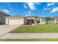 Charming single-story home featuring a well-manicured lawn and a two-car garage at 2746 Windsorgate Ln, Orlando, FL 32828