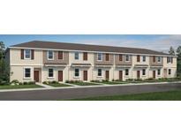 Charming townhome exterior featuring neutral siding, shuttered windows, and well-manicured landscaping at 3064 Skyline Loop, Kissimmee, FL 34758