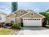 Charming single-story home features a two-car garage, brick accents, and well-maintained landscaping at 3065 Bridgehampton Ln, Orlando, FL 32812