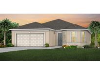 Charming single-story home with a two-car garage and well-manicured landscaping at 3245 Ellsworth Ave, Davenport, FL 33837