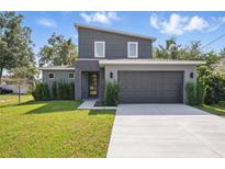 Modern two-story home with dark gray stucco, stone accents, manicured lawn, and large driveway at 3650 Grant Blvd, Orlando, FL 32804