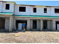 Unfinished townhouse exteriors showing the beginning stages of construction with open window and door frames at 4252 Campsite Loop, Orlando, FL 32824