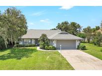 Charming single-story home features a well-manicured lawn and a two-car garage at 5382 Sw 84Th Pl, Ocala, FL 34476