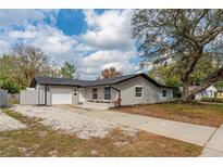 Charming one-story home with a well-manicured lawn, front flower bed, and an attached one-car garage at 540 Diane Cir, Casselberry, FL 32707
