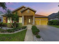 Charming one-story home with a well-manicured lawn, two-car garage, and inviting entryway at 9780 Cypress Pine St, Orlando, FL 32827