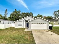 Charming single-Gathering home with a well-maintained lawn and attached two-car garage at 9821 8Th Ave, Orlando, FL 32824