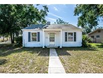 Charming one-story home with a walkway leading to the front door and classic curb appeal at 1003 S Center St, Eustis, FL 32726