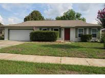 Charming single-story home with a well-maintained front yard and a two-car garage at 10208 Brownwood Ave, Orlando, FL 32825