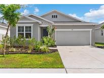 Charming single-story home features a well-maintained lawn, landscaping, and a two-car garage at 1120 Mattie Pointe Blvd, Auburndale, FL 33823