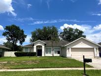 Charming single-story home with a well-manicured lawn and attached two-car garage at 1131 Turtle Lake Ct, Ocoee, FL 34761