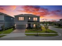 Charming two-story home featuring manicured lawn, tasteful landscaping, and a two car garage at 13822 Destin Beach Ln, Orlando, FL 32827