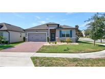 Charming single-story home featuring a well-maintained lawn and inviting brick driveway at 1727 Butterfly Way, Longwood, FL 32750