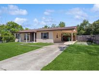 Charming single-story home featuring a covered carport and a well-maintained front yard at 2822 Fulford St, Deltona, FL 32738