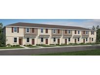 Charming townhome with neutral siding, shuttered windows and a well-maintained lawn and garden at 3056 Skyline Loop, Kissimmee, FL 34758
