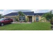 Charming single-story home with a well-manicured lawn and beautiful landscaping at 3600 Fountainbleu Blvd, Kissimmee, FL 34746