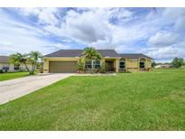 Charming one-story home with lush green lawn, mature landscaping, and a paved driveway at 3600 Fountainbleu Blvd, Kissimmee, FL 34746