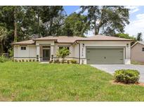 Charming single-story home with a well-manicured lawn and a two-car garage at 4770 Drummond Ln, Orlando, FL 32810