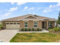 Charming single-story home with manicured lawn, stone accents, and a neutral color palette at 9846 Sw 106Th Ct Ocala, F, Ocala, FL 34481
