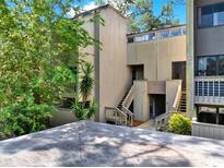Multi-level exterior of home with stairs, greenery, and a view of a concrete roof at 109 Crown Oaks Way # 109, Longwood, FL 32779