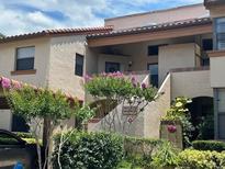 Charming townhome with colorful landscaping and a well-maintained facade offering curb appeal at 1252 Lake Willisara Cir # Ge, Orlando, FL 32806
