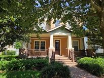 Charming two-story home featuring a welcoming front porch and professionally landscaped yard at 1414 Stickley Ave, Kissimmee, FL 34747