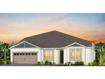 Charming one-story home featuring a two-car garage, well-manicured lawn and a neutral color palette at 16352 Crown Top Dr, Montverde, FL 34756