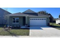 Charming one-story home featuring a two-car garage and well-maintained landscaping at 220 Taylor Groves St, Lake Wales, FL 33898