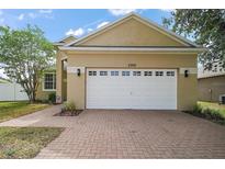 Charming single-Gathering home with a two-car garage and brick paver driveway at 2306 Valhalla Dr, Tavares, FL 32778