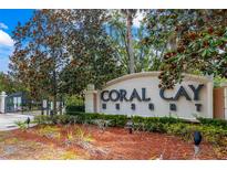 A welcoming community entrance with lush landscaping and prominent signage at 2411 Caravelle Cir, Kissimmee, FL 34746