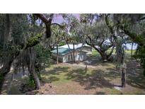 Charming home exterior featuring a lush, tree-filled yard with scenic views at 2518 Fort Lane Rd, Geneva, FL 32732
