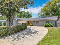 Charming one-story home with a winding driveway, mature landscaping, and an attached garage at 3443 Arnel Dr, Winter Park, FL 32792