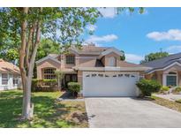 Charming two-story home features a well-maintained lawn, mature trees, and an attached two-car garage at 5113 Mystic Point Ct, Orlando, FL 32812
