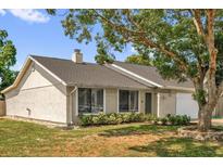 Charming single-story home featuring a well-maintained lawn and mature trees providing ample shade at 5575 Garden Grove Cir, Winter Park, FL 32792