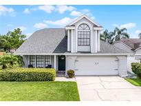 Charming two-story home with a well-manicured lawn, lush green bushes, and a welcoming front entrance at 754 Birgham Pl, Lake Mary, FL 32746