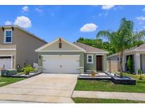 Charming single-Gathering home with a well-manicured lawn, inviting entry, and two-car garage at 1287 Berry Ln, Davenport, FL 33837