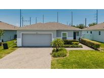 Charming single-story home with a well-manicured lawn and a two car garage at 14357 Hidden Ct, Clermont, FL 34711