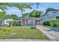 Charming single-story home featuring a quaint front porch, covered parking, and a well-maintained lawn at 1511 Chestnut Ave, Winter Park, FL 32789