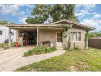 Charming single-story home with a covered carport and a neatly maintained front yard at 205 W Division St, Deland, FL 32720