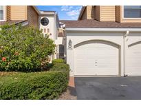 Charming townhome featuring a garage, arched entryway, and well-maintained landscaping at 2926 Claremont Ct # Ge, Orlando, FL 32822