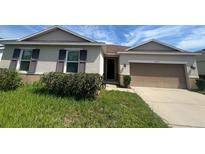 Charming single-story home featuring a two-car garage, and low-maintenance landscaping at 2983 Boating Blvd, Kissimmee, FL 34746