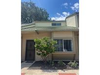 Two-story home featuring neutral color scheme, wrought iron door, and well-maintained landscaping at 460 Sand Lime Rd, Winter Garden, FL 34787