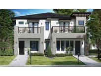 Charming new construction two-story home featuring modern design, balconies, and lush landscaping at 513 W Princeton St # 4, Orlando, FL 32804