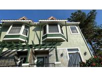 Inviting townhouse featuring charming architectural details and a lush garden entrance at 14501 Damai Ln, Orlando, FL 32821
