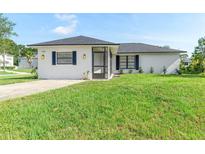 Charming single-story home featuring a well-maintained lawn and a welcoming front porch at 1750 Mitten Ter, Deltona, FL 32738