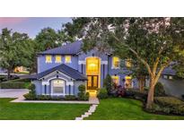 Stunning two-story home featuring a meticulously landscaped yard and elegant architectural details at 245 Via Siena Ln, Lake Mary, FL 32746