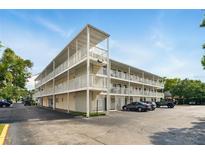 Condo building with three stories, exterior staircases, parking, and white facade at 320 Lakeview St # 220, Orlando, FL 32804