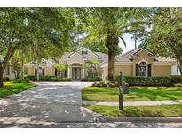 Beautiful front exterior with well-manicured lawn and mature trees at 3381 Regal Crest Dr, Longwood, FL 32779