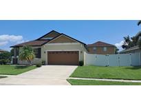 Charming single-story home with well-manicured lawn and a two-car garage at 3529 Harlequin Dr, St Cloud, FL 34772